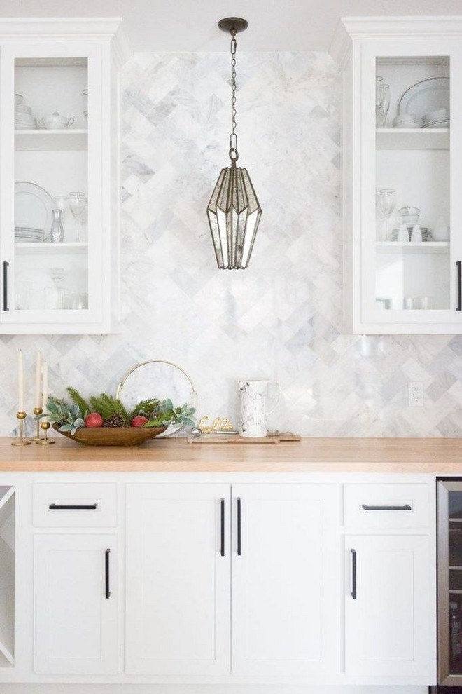 Example of a mid-sized transitional l-shaped dark wood floor and brown floor eat-in kitchen design in Columbus with a farmhouse sink, recessed-panel cabinets, white cabinets, wood countertops, gray backsplash, stone tile backsplash, stainless steel appliances and brown countertops