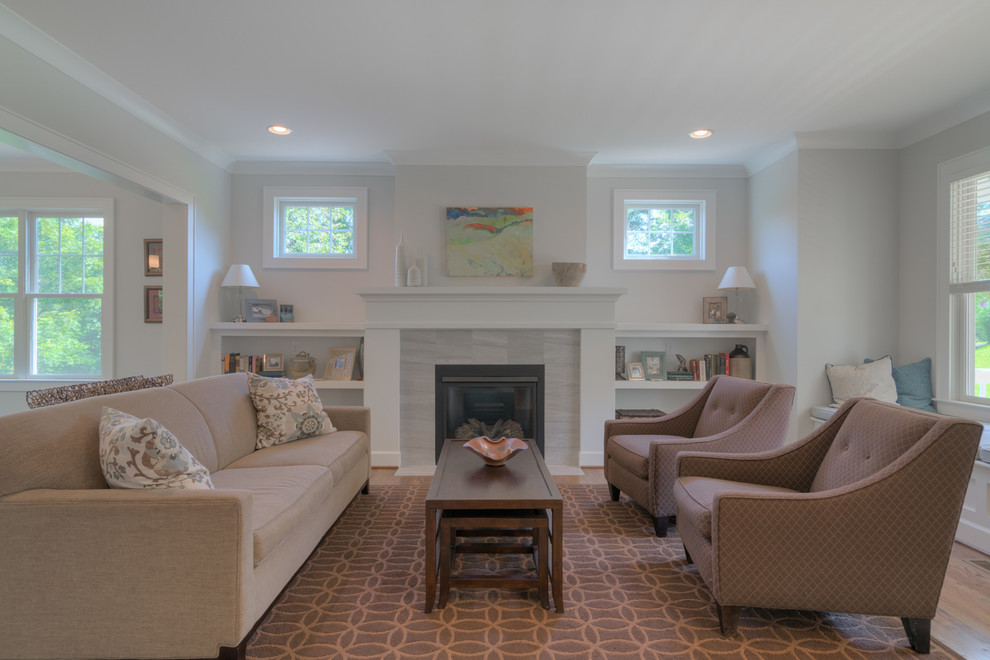 This is an example of a mid-sized arts and crafts open concept living room in Other with light hardwood floors, a standard fireplace, a stone fireplace surround and grey walls.