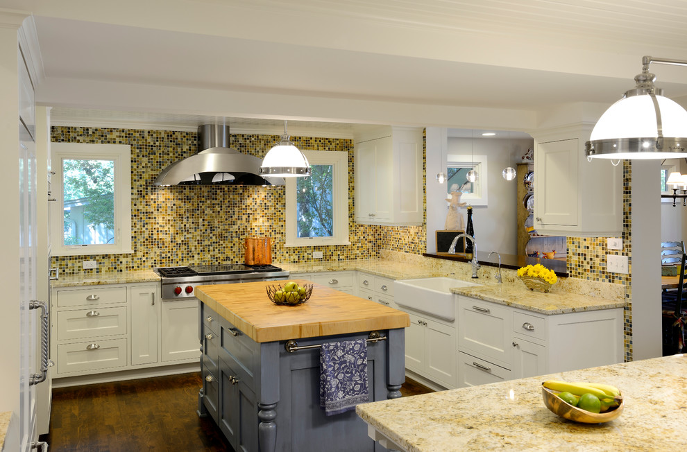 Inspiration for a traditional u-shaped kitchen in Minneapolis with a farmhouse sink, shaker cabinets, white cabinets, multi-coloured splashback, mosaic tile splashback and stainless steel appliances.