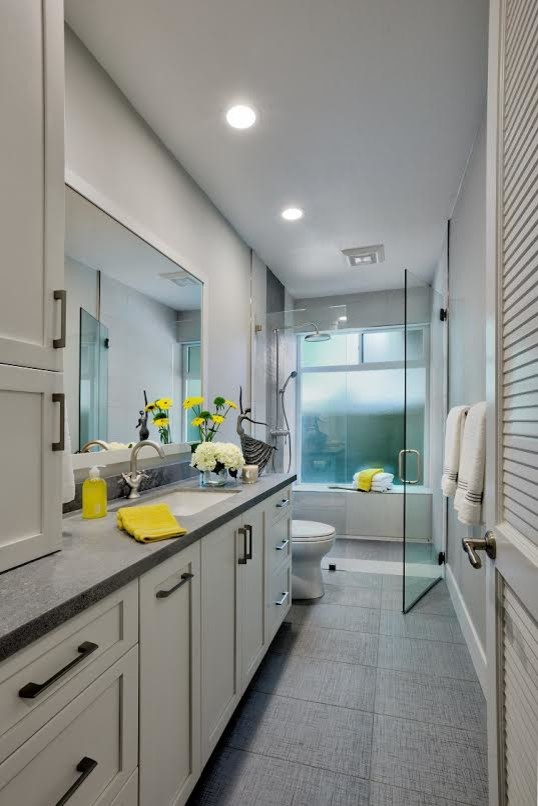 Mid-sized transitional master porcelain tile and gray floor walk-in shower photo in Sacramento with shaker cabinets, white cabinets, gray walls, an undermount sink, a hinged shower door, gray countertops and quartz countertops