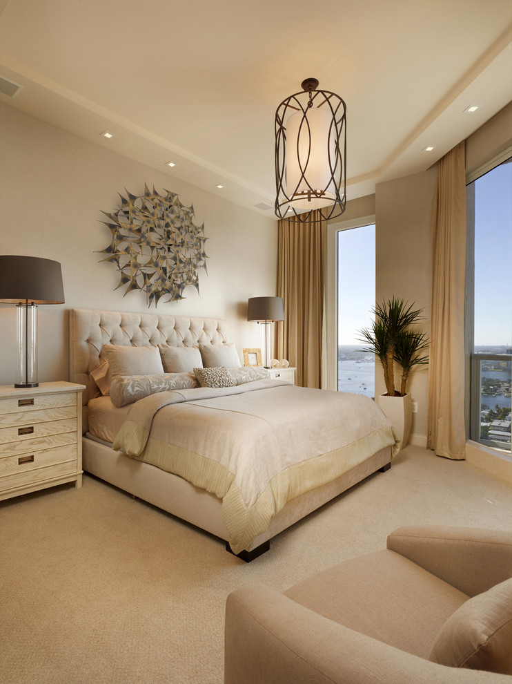 Inspiration for a mid-sized transitional master bedroom in Miami with beige walls and carpet.