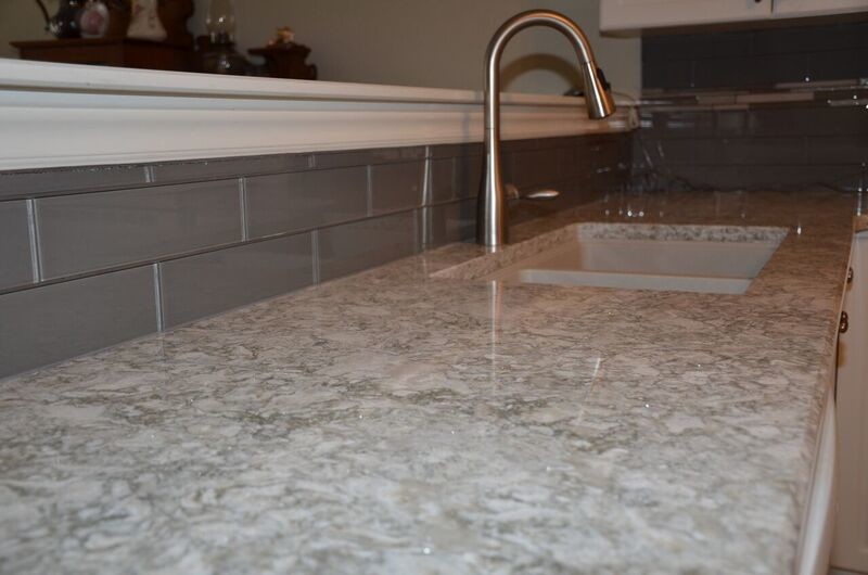 Mid-sized transitional u-shaped vinyl floor open concept kitchen photo in Toronto with an undermount sink, raised-panel cabinets, white cabinets, quartzite countertops, gray backsplash, glass tile backsplash, white appliances and a peninsula
