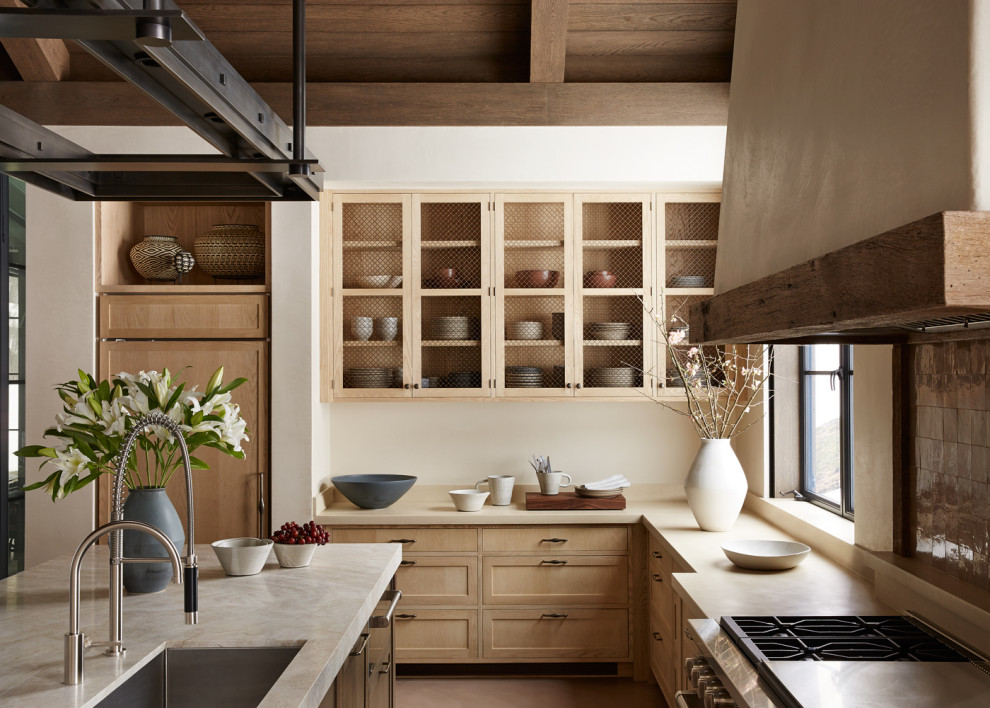Large mountain style l-shaped brown floor, exposed beam, vaulted ceiling and wood ceiling enclosed kitchen photo with an island, an undermount sink, shaker cabinets, light wood cabinets and beige countertops