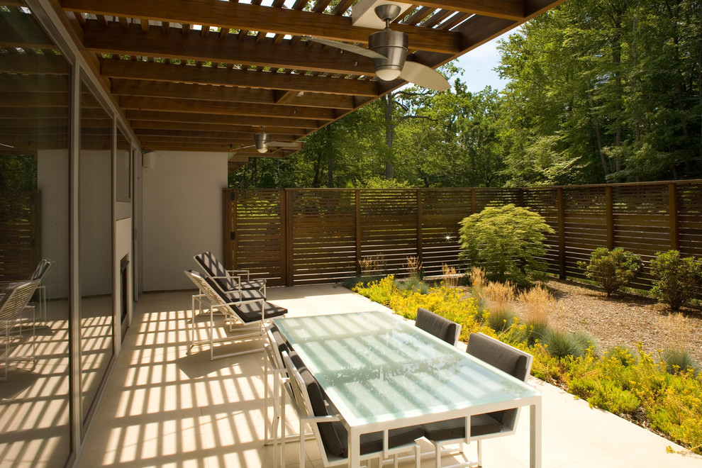 Design ideas for a contemporary patio in New York with natural stone pavers and a pergola.