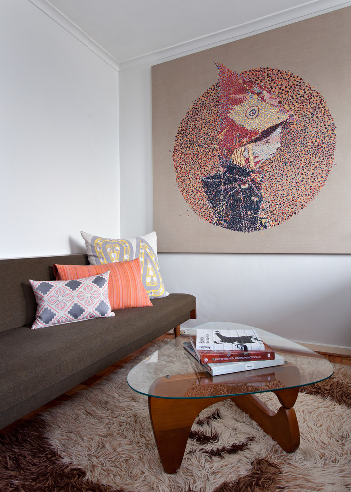 This is an example of a small midcentury living room in Melbourne.
