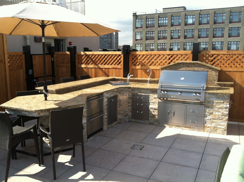 Example of a mid-sized transitional rooftop outdoor kitchen deck design in New York with no cover