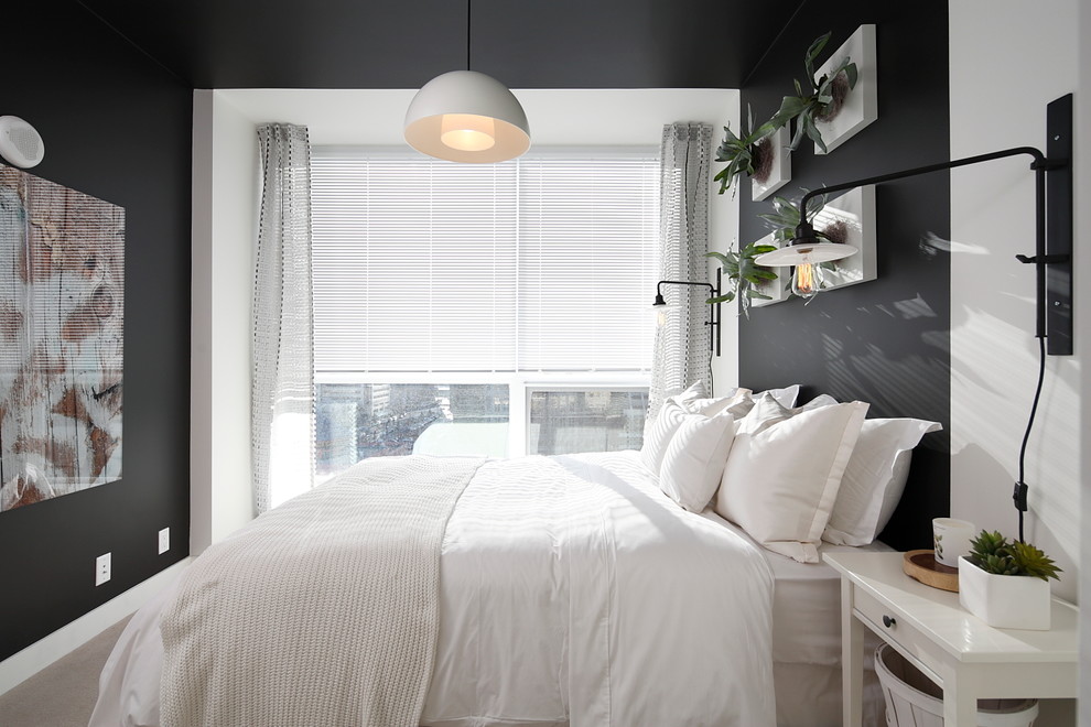 This is an example of a contemporary bedroom in Calgary with black walls.