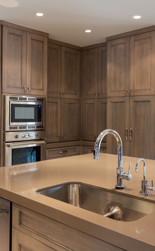 Eat-in kitchen - large transitional eat-in kitchen idea in Houston with a double-bowl sink, recessed-panel cabinets, medium tone wood cabinets, granite countertops, stainless steel appliances and an island