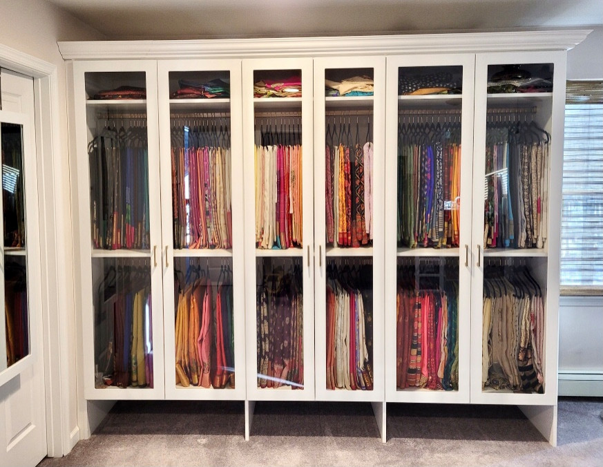 Ejemplo de armario unisex tradicional renovado pequeño con armarios tipo vitrina, puertas de armario blancas, moqueta y suelo beige