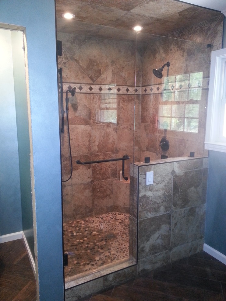 Photo of a large contemporary master bathroom in Atlanta with a corner shower, blue walls and medium hardwood floors.