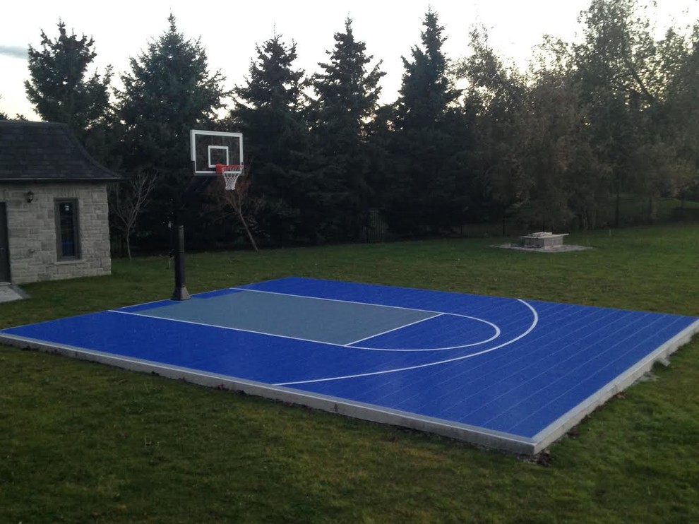 Photo of a mid-sized traditional backyard partial sun outdoor sport court for summer in Toronto with with outdoor playset and concrete pavers.