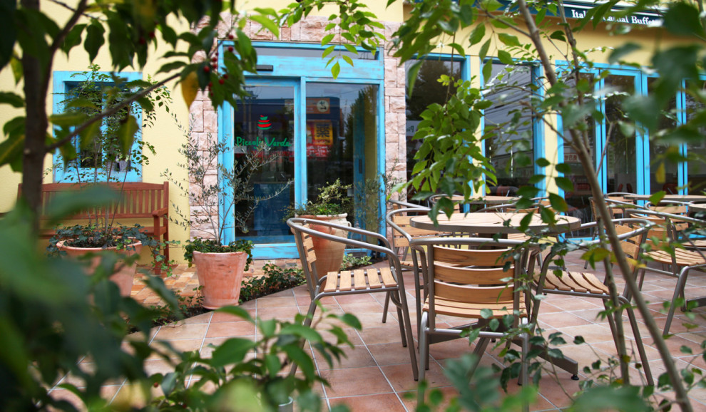 Inspiration for a mid-sized mediterranean front yard tile patio remodel in Yokohama with an awning