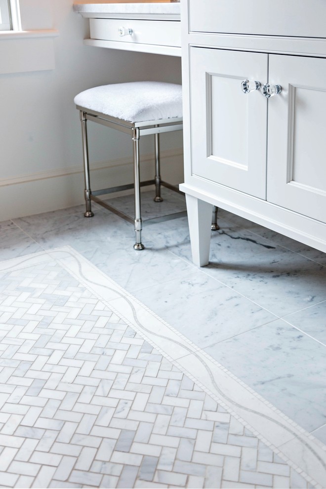 Inspiration for a small traditional bathroom in Boston with an undermount sink, recessed-panel cabinets, white cabinets, marble benchtops, an alcove tub, a shower/bathtub combo, a two-piece toilet, white tile, stone slab, white walls and marble floors.