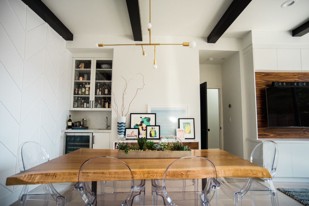 Small transitional open plan dining in San Francisco with white walls and light hardwood floors.