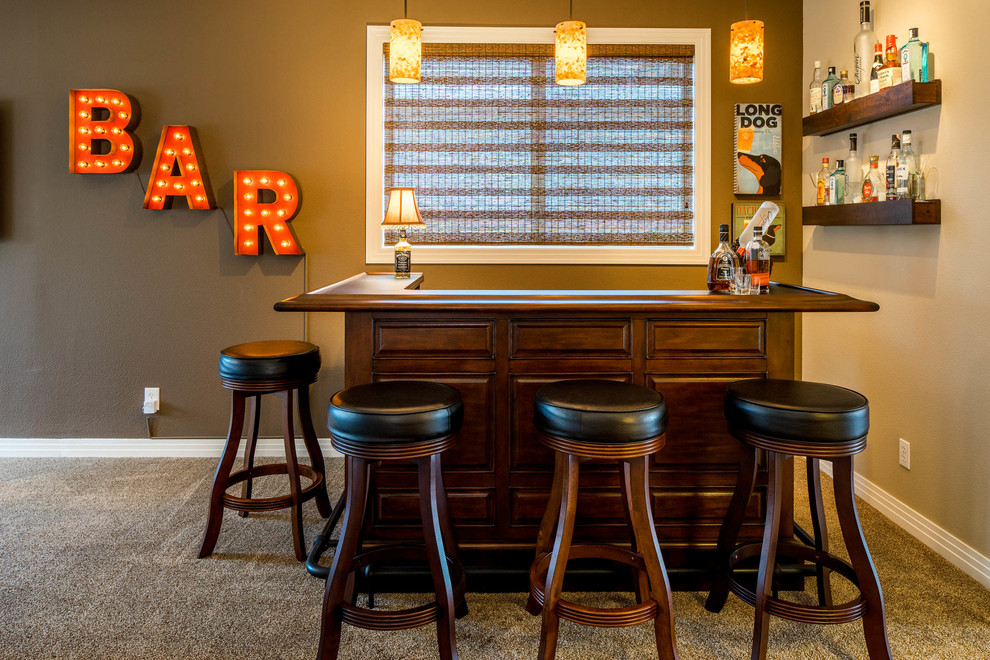 Inspiration for a large traditional u-shaped seated home bar in Portland with carpet, raised-panel cabinets, dark wood cabinets and wood benchtops.