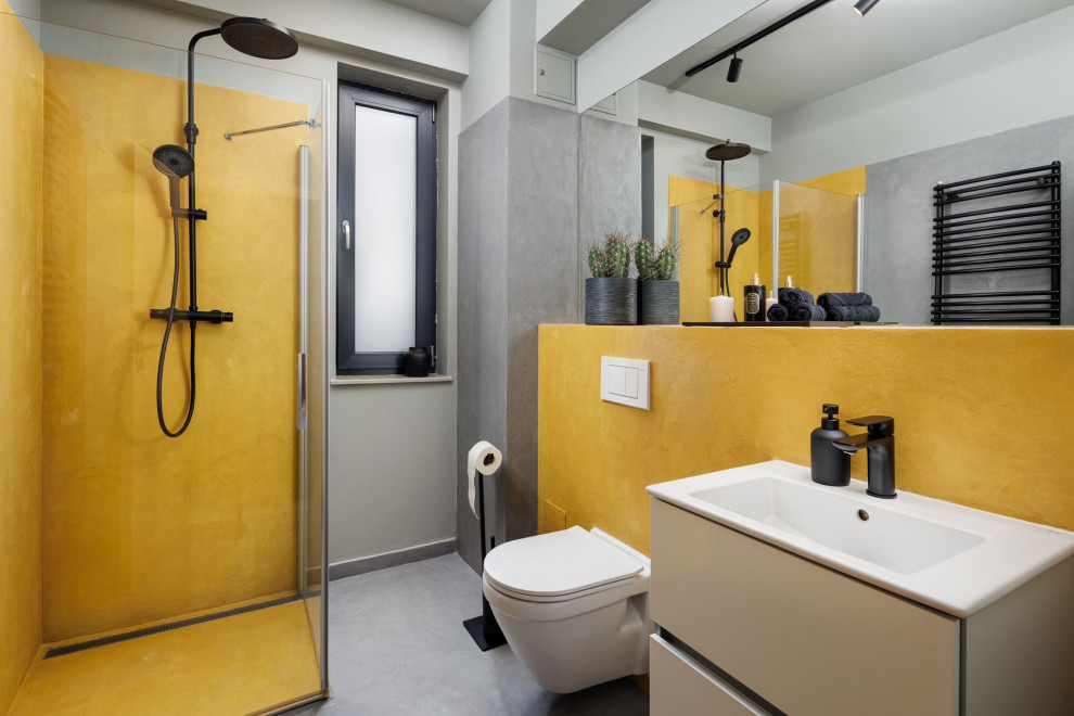 Contemporary bathroom with flat-panel cabinets, beige cabinets, a corner shower, yellow tile, grey walls, an integrated sink, grey floor, a hinged shower door, white benchtops, a single vanity and a floating vanity.