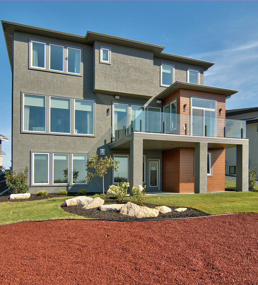 This is an example of a mid-sized contemporary two-storey stucco exterior in Other.