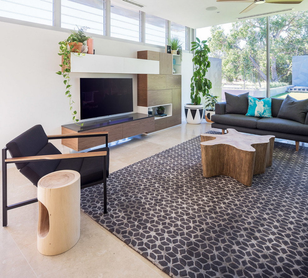 Large contemporary open concept living room in Perth with white walls, limestone floors, a wall-mounted tv and beige floor.