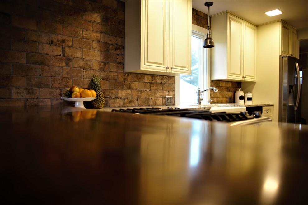 Example of a mid-sized mountain style galley ceramic tile and white floor home design design in DC Metro with white cabinets, wood countertops, stainless steel appliances and two islands