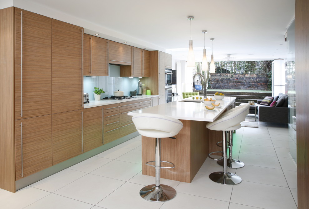 Photo of a contemporary kitchen in London with flat-panel cabinets and light wood cabinets.