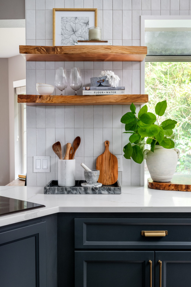 Mid-sized transitional l-shaped dark wood floor and brown floor eat-in kitchen photo in Seattle with a farmhouse sink, shaker cabinets, blue cabinets, quartz countertops, white backsplash, porcelain backsplash, stainless steel appliances, a peninsula and white countertops