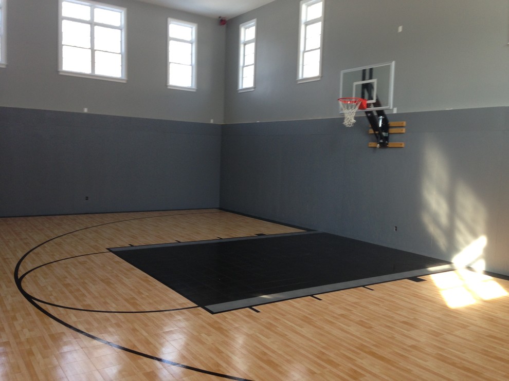 Design ideas for a mid-sized traditional indoor sport court in Boston with light hardwood floors and grey walls.