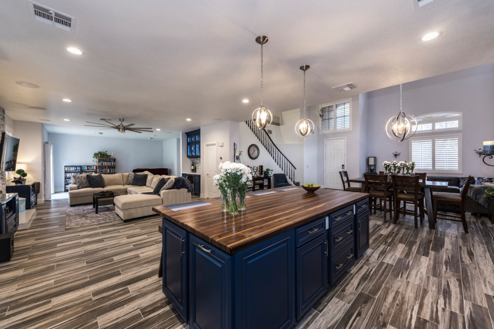 Kitchen - large transitional l-shaped kitchen idea in Las Vegas with blue cabinets, quartz countertops and an island