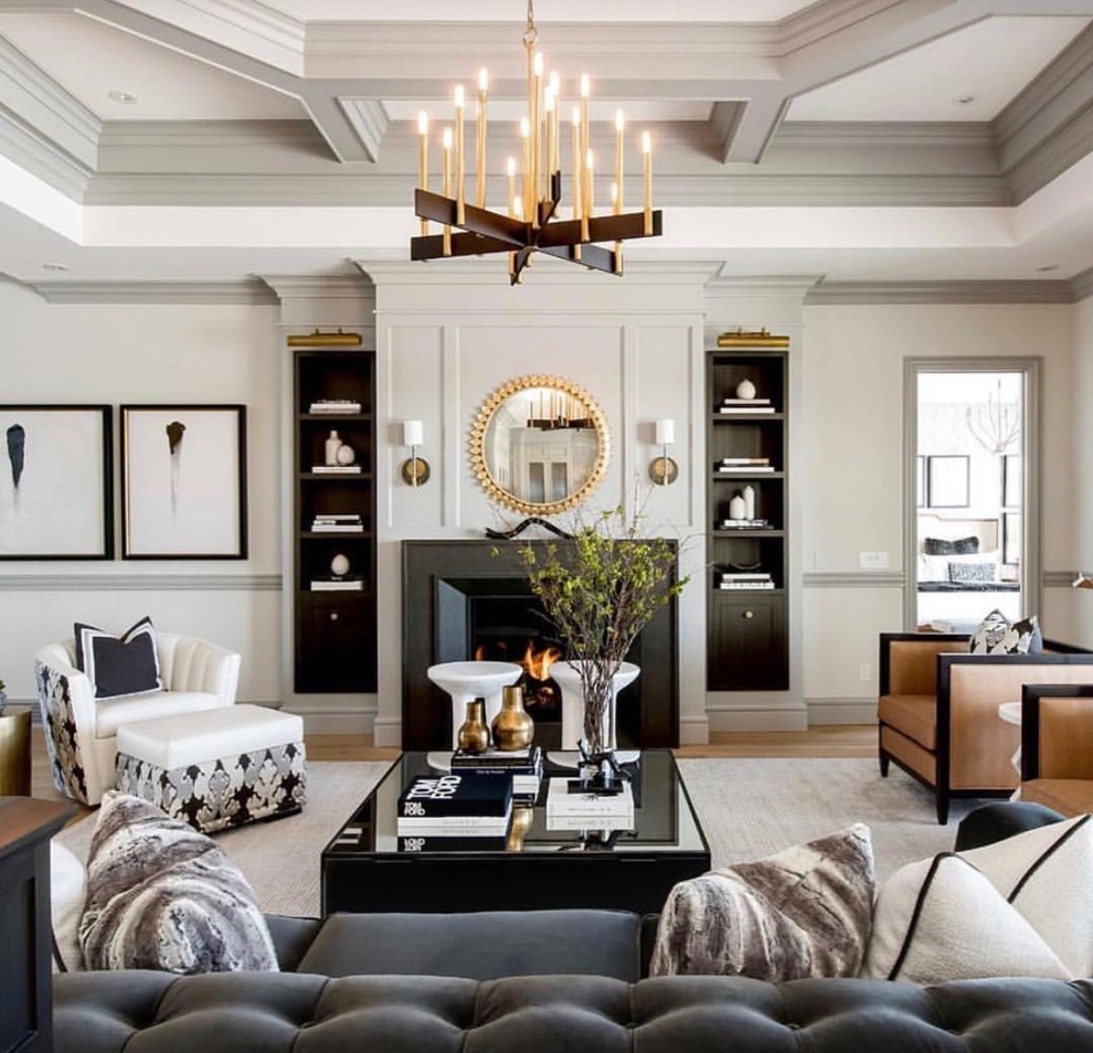 This is an example of a transitional formal living room in Atlanta with white walls, medium hardwood floors, a standard fireplace and brown floor.