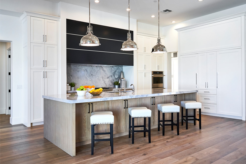 Example of a transitional kitchen design in Phoenix with shaker cabinets and white cabinets