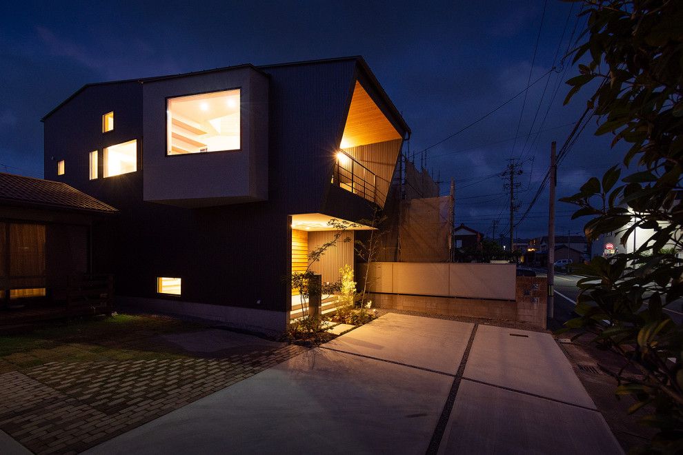 Inspiration för ett litet minimalistiskt grått hus, med två våningar, metallfasad, halvvalmat sadeltak och tak i metall