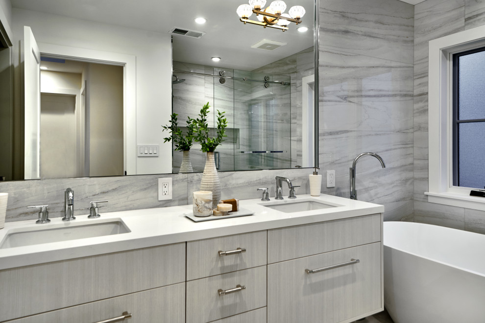 Design ideas for a mid-sized contemporary master bathroom in San Francisco with flat-panel cabinets, grey cabinets, a freestanding tub, an alcove shower, gray tile, an undermount sink, a sliding shower screen, white benchtops, a double vanity and a floating vanity.