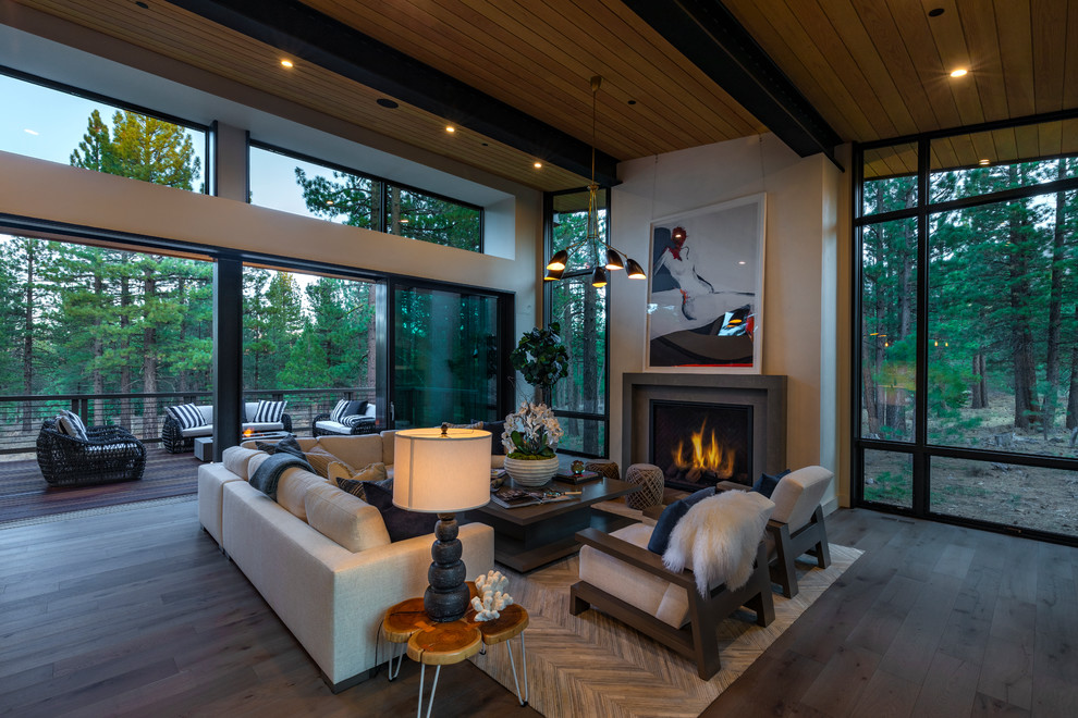 Photo of a large modern open concept living room in Other with white walls, a standard fireplace, no tv, light hardwood floors, a stone fireplace surround and beige floor.
