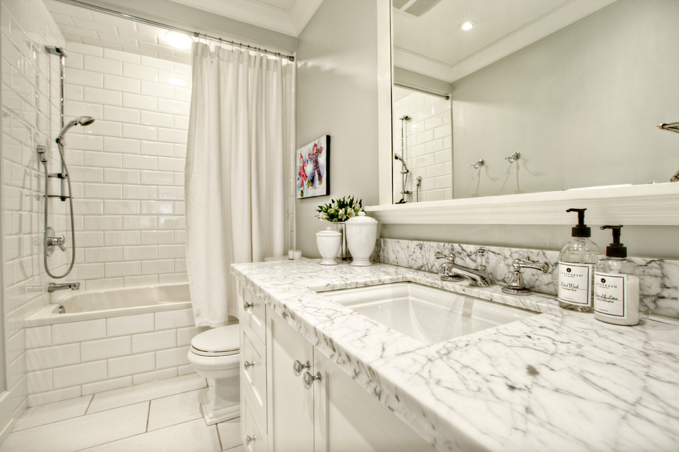 Traditional bathroom in Calgary with an undermount sink, shaker cabinets, white cabinets, an alcove tub, a shower/bathtub combo, white tile and subway tile.