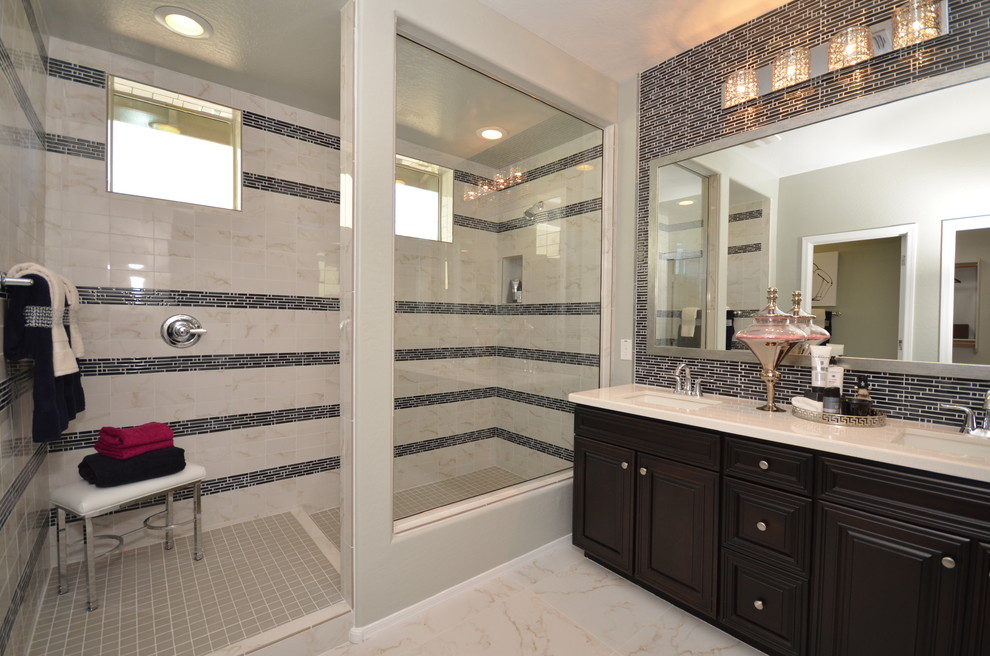 Inspiration for a large traditional master bathroom in Phoenix with an undermount sink, raised-panel cabinets, dark wood cabinets, engineered quartz benchtops, an alcove shower, a one-piece toilet, white tile, porcelain tile, grey walls and porcelain floors.