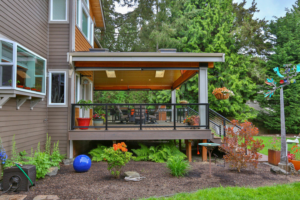 Design ideas for a large modern backyard deck in Seattle with an outdoor kitchen and a roof extension.
