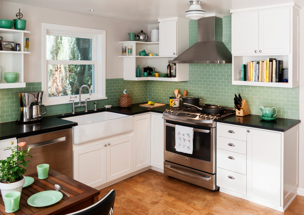 Inspiration for a small u-shaped separate kitchen in Seattle with a farmhouse sink, shaker cabinets, white cabinets, green splashback, stainless steel appliances, cork floors, no island and subway tile splashback.