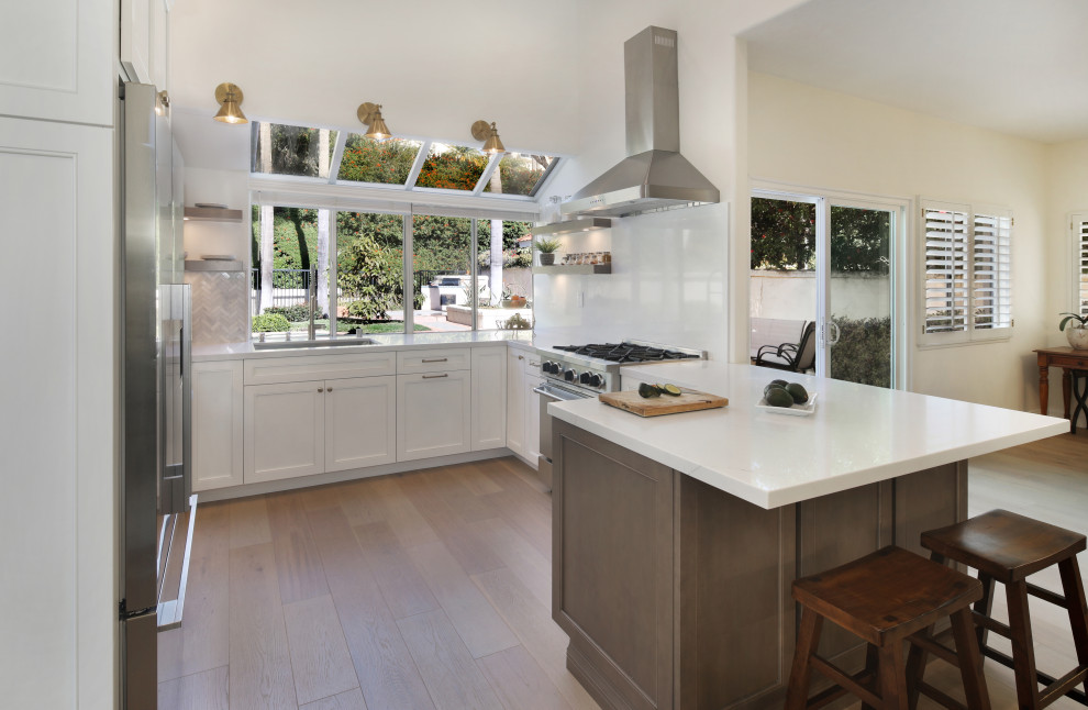 Design ideas for a large contemporary u-shaped eat-in kitchen in Orange County with an undermount sink, recessed-panel cabinets, white cabinets, quartz benchtops, multi-coloured splashback, engineered quartz splashback, stainless steel appliances, a peninsula, beige floor and yellow benchtop.