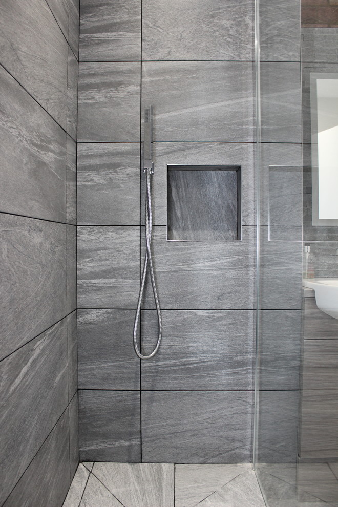 Photo of a small contemporary 3/4 bathroom in London with an open shower, a one-piece toilet, gray tile, porcelain tile, grey walls, porcelain floors, a drop-in sink and laminate benchtops.