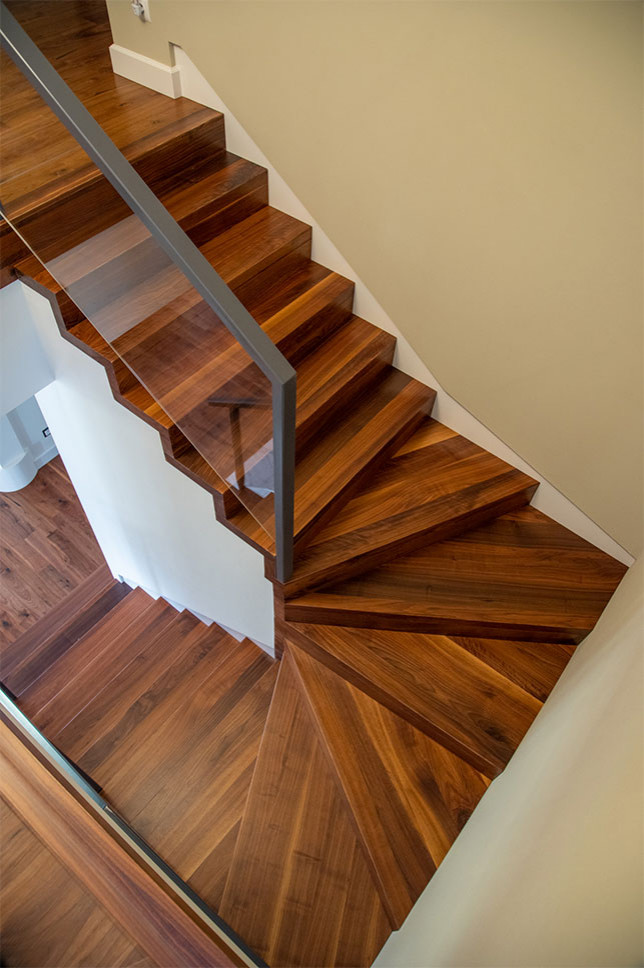 Inspiration for a country wood u-shaped staircase in Other with wood risers and glass railing.