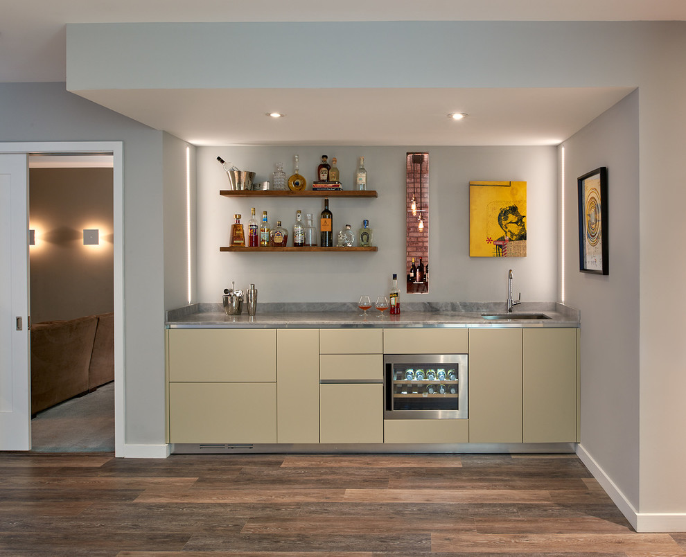 This is an example of a mid-sized contemporary single-wall home bar in DC Metro with flat-panel cabinets.