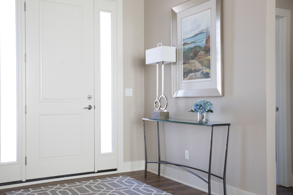 Inspiration for a mid-sized transitional foyer in Other with beige walls, vinyl floors, a single front door, a white front door and brown floor.