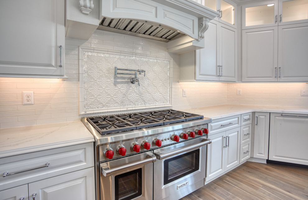 Transitional Kitchen with Two Toned Gathering Island & Archways