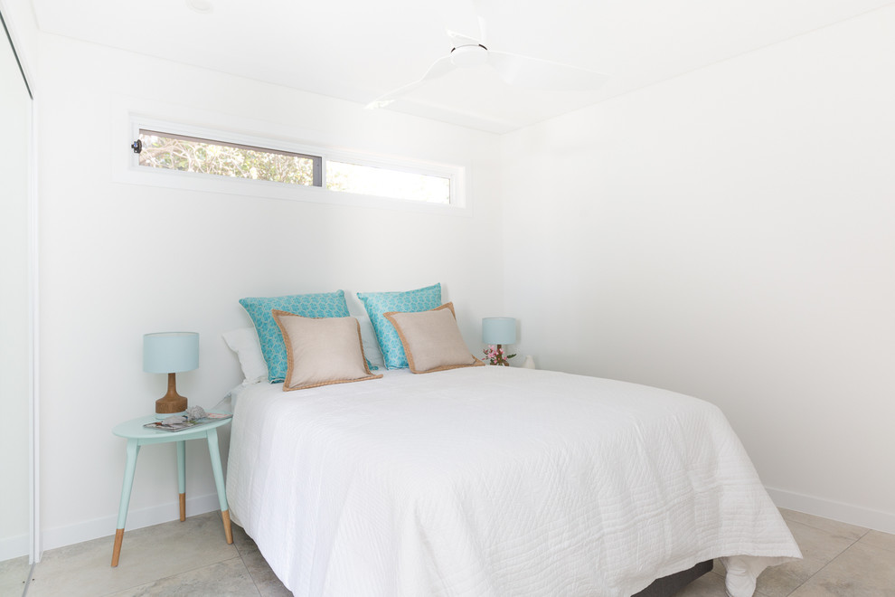 This is an example of a small modern master bedroom in Sydney with white walls and ceramic floors.