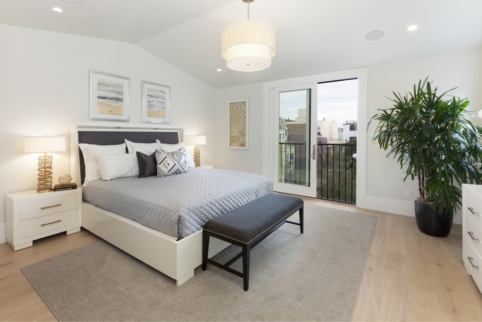 Photo of a mid-sized transitional guest bedroom in San Francisco with white walls and light hardwood floors.