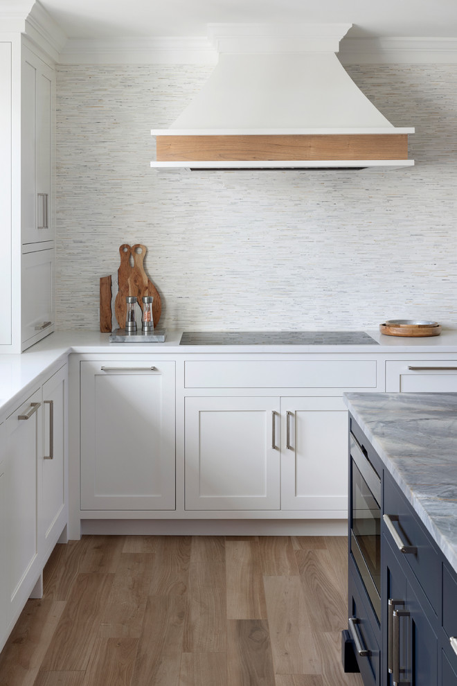 Inspiration for a mid-sized transitional u-shaped porcelain tile and beige floor eat-in kitchen remodel in Bridgeport with an undermount sink, shaker cabinets, white cabinets, quartzite countertops, white backsplash, mosaic tile backsplash, stainless steel appliances, an island and multicolored countertops
