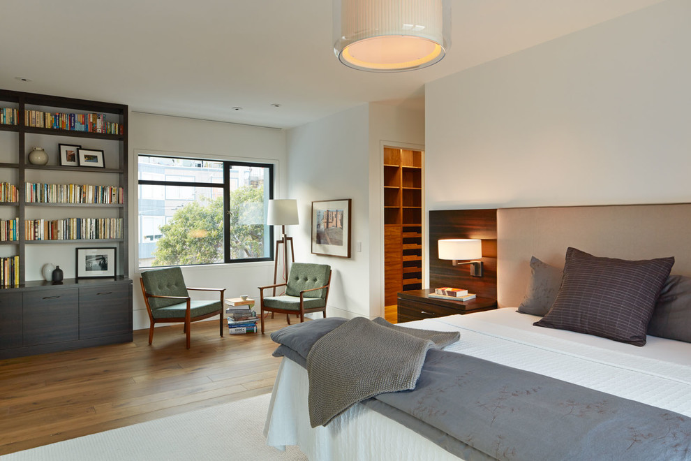 Design ideas for a contemporary bedroom in San Francisco with white walls and medium hardwood floors.