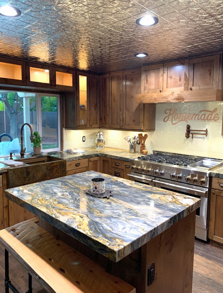 Medium sized rustic l-shaped kitchen/diner in Los Angeles with a belfast sink, shaker cabinets, medium wood cabinets, white splashback, stainless steel appliances, medium hardwood flooring, an island and multicoloured worktops.
