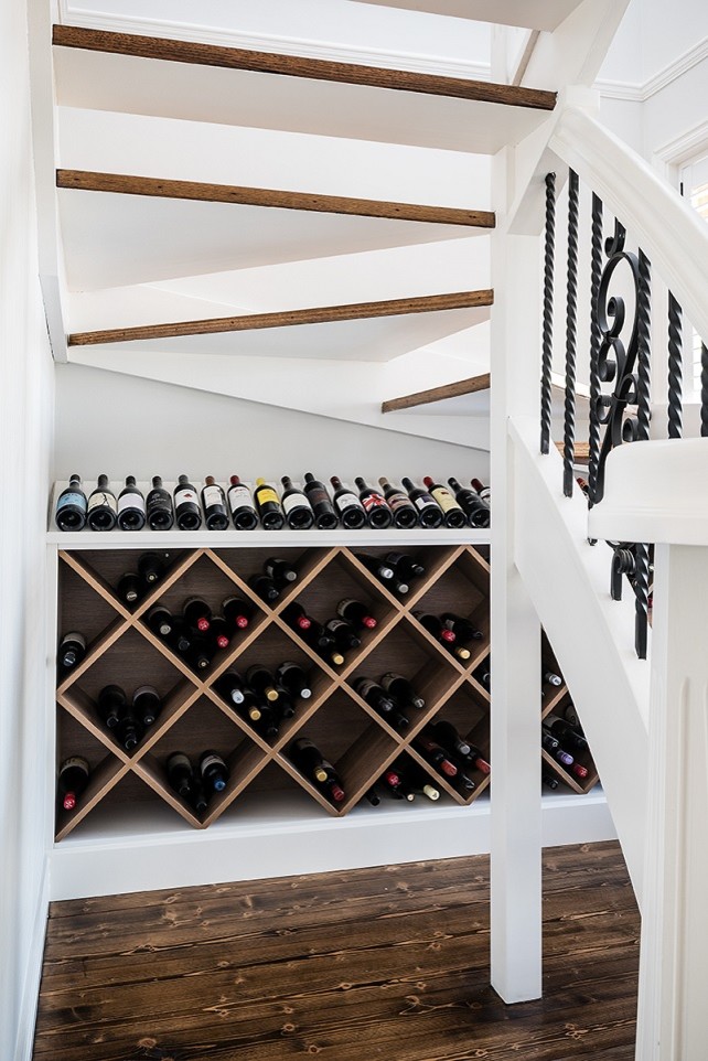 Large traditional wine cellar in Melbourne with dark hardwood floors and brown floor.