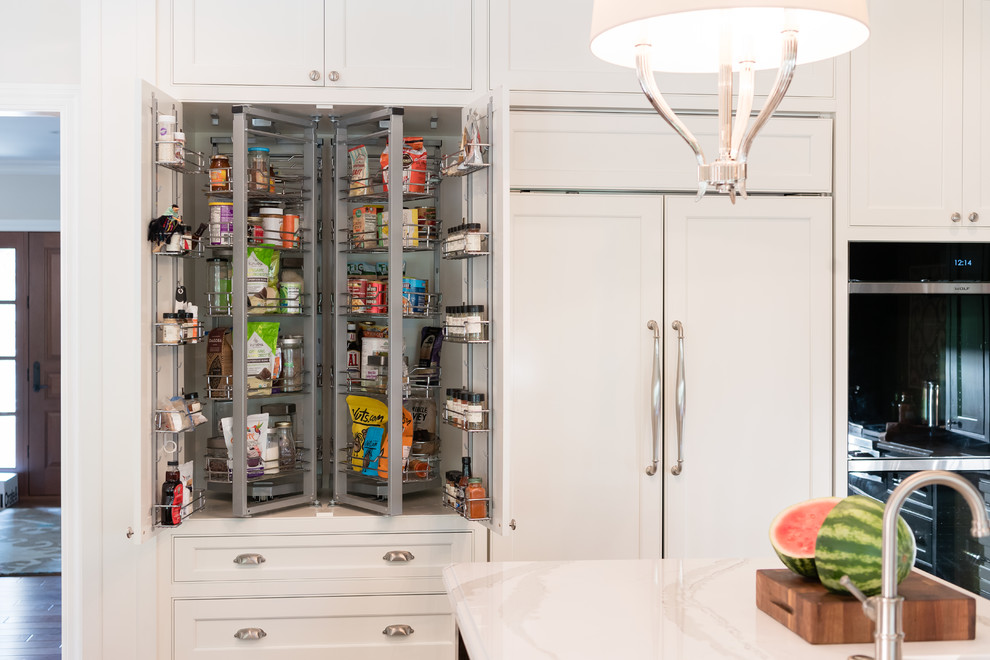 Inspiration for a transitional kitchen pantry in Cleveland with shaker cabinets and white cabinets.