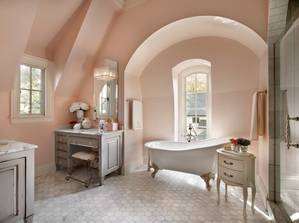 Traditional bathroom in Chicago with marble benchtops and pink walls.